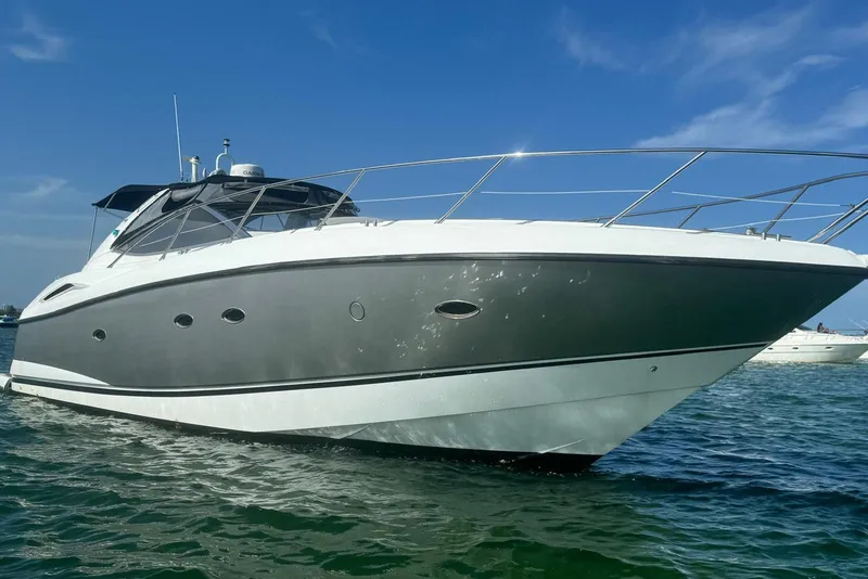 Slide: The Image of 2006 Sunseeker Portofino 47 yacht on clear blue water under sunny sky. - 11