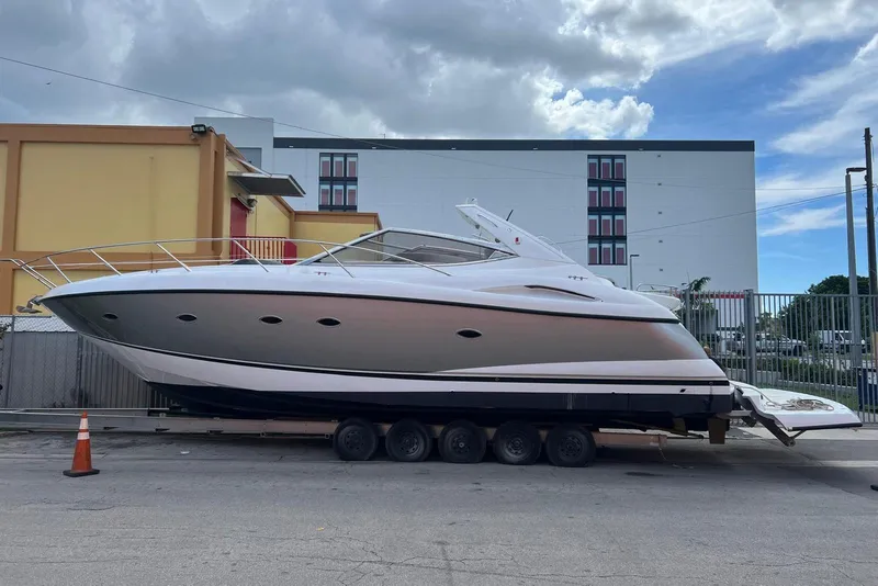 Slide: The Image of 2006 Sunseeker Portofino 47 yacht on trailer, urban background, cloudy sky. - 12