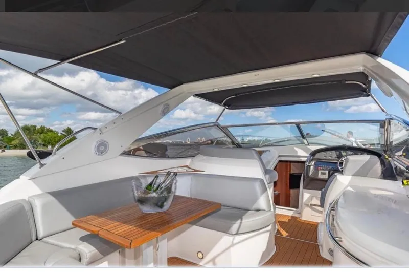Slide: The Image of 2006 Sunseeker Portofino 47 yacht interior with seating and table under canopy. - 3