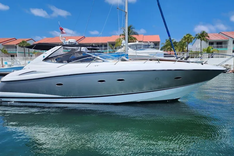 Slide: The Image of 2006 Sunseeker Portofino 47 yacht docked in a sunny marina setting. - 8