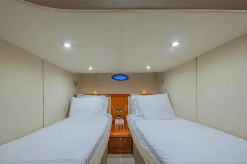 Slide: The Image of Interior cabin of 2006 Sunseeker Portofino 47 yacht with twin beds and modern lighting. - 9