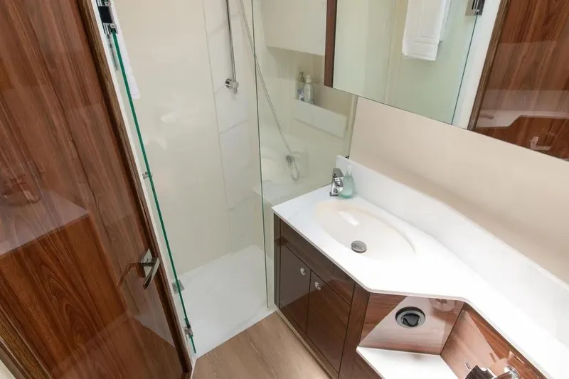 Slide: The Image of Luxurious bathroom in 2024 Maritimo M55 yacht with modern fixtures and wood accents. - 10