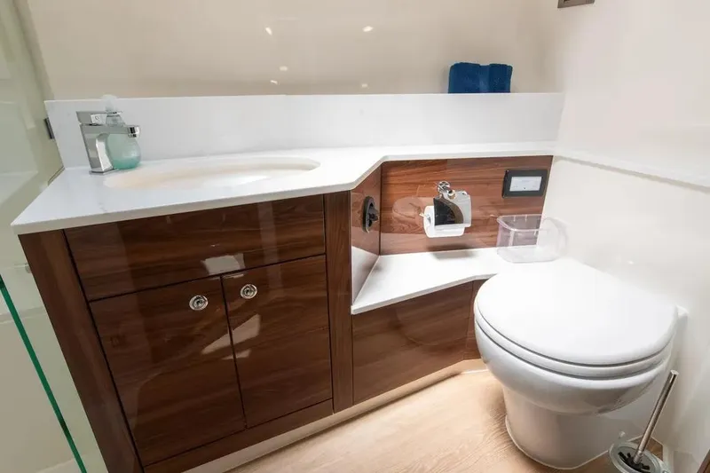 Slide: The Image of Luxurious 2024 Maritimo M55 yacht bathroom with modern fixtures and elegant wood cabinetry. - 14