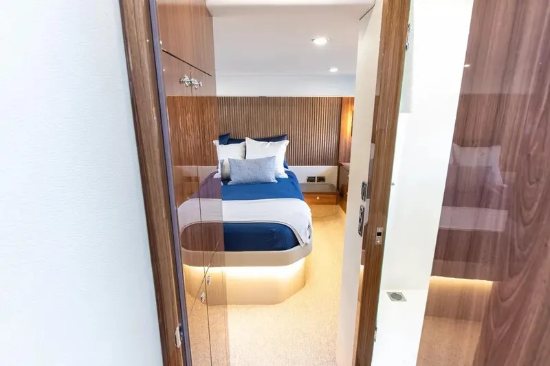 Slide: The Image of Luxurious bedroom interior of 2024 Maritimo M55 yacht with modern design and ambient lighting. - 15