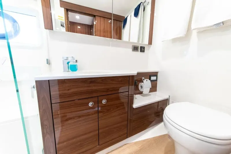 Slide: The Image of Luxurious bathroom in 2024 Maritimo M55 yacht with wooden cabinetry and modern fixtures. - 16