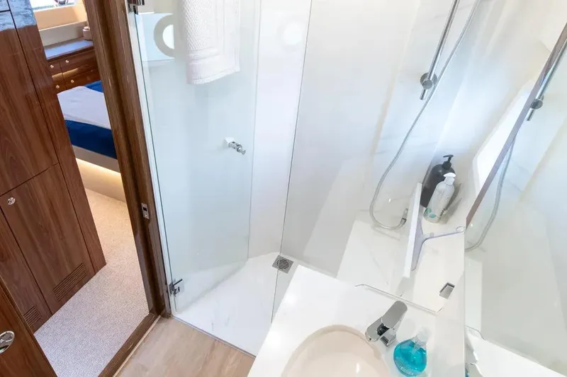 Slide: The Image of Luxurious bathroom in 2024 Maritimo M55 yacht, featuring modern shower and elegant wood accents. - 17