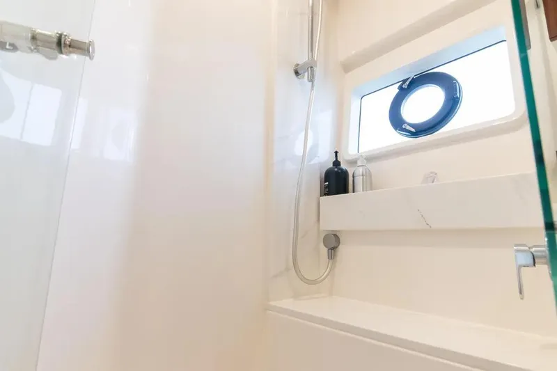 Slide: The Image of Luxurious shower area in 2024 Maritimo M55 yacht with modern fixtures and porthole window. - 18