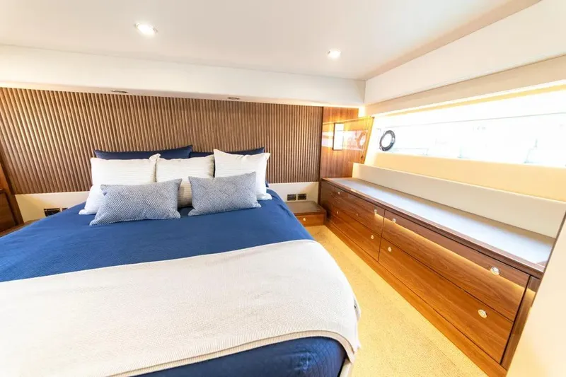 Slide: The Image of Luxurious bedroom interior of 2024 Maritimo M55 yacht with elegant wood accents. - 19