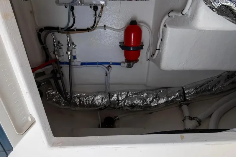 Slide: The Image of Engine room of 2024 Maritimo M55 yacht with visible piping and fire extinguisher. - 27