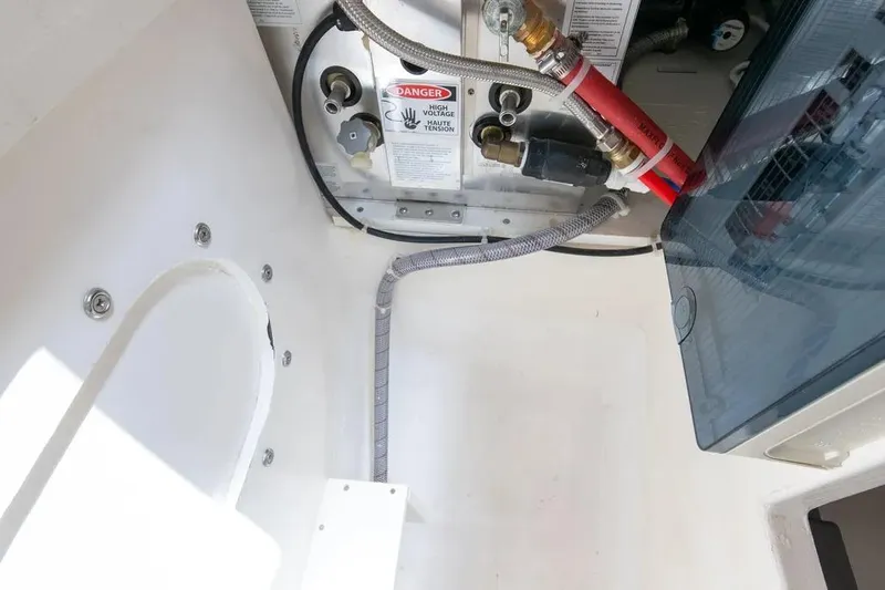 Slide: The Image of 2024 Maritimo M55 yacht engine compartment with wiring and warning label. - 28