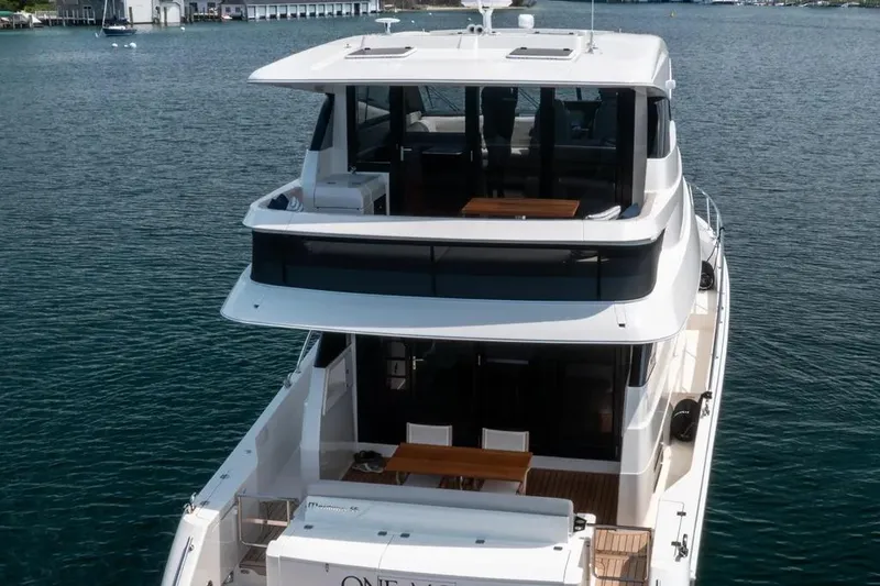 Slide: The Image of 2024 Maritimo M55 luxury yacht on calm water, showcasing sleek design and spacious decks. - 4