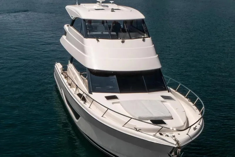 Slide: The Image of 2024 Maritimo M55 luxury yacht on calm blue water, showcasing sleek design and spacious deck. - 5