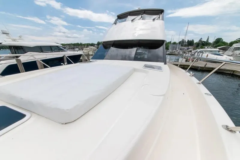 Slide: The Image of 2024 Maritimo M55 yacht docked at marina, showcasing sleek design and spacious deck. - 50