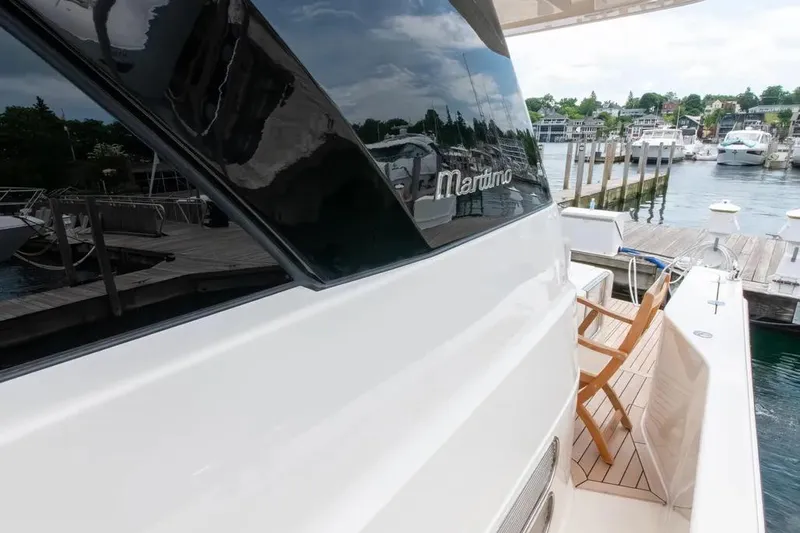 Slide: The Image of 2024 Maritimo M55 yacht docked at a marina, showcasing sleek design and luxury. - 52