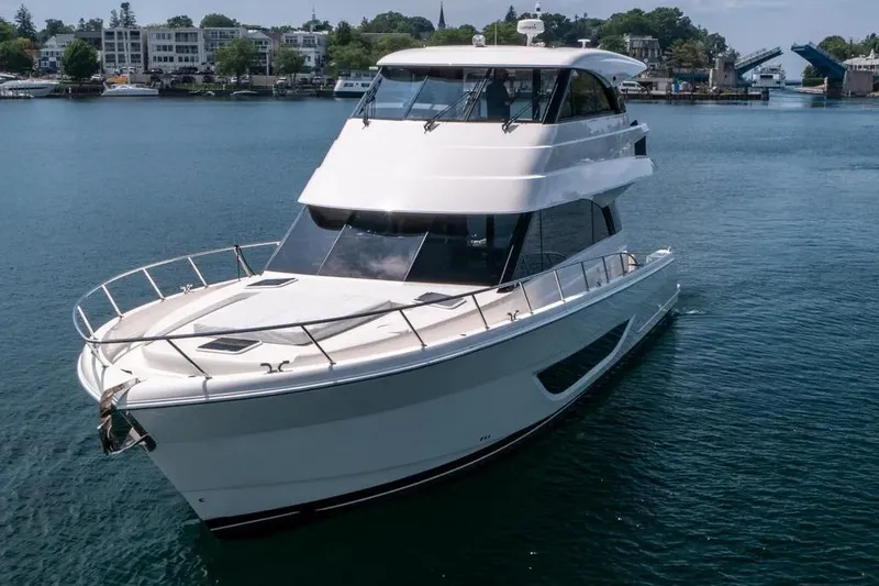 Slide: The Image of 2024 Maritimo M55 yacht cruising on a serene waterway, showcasing sleek design and luxury. - 6