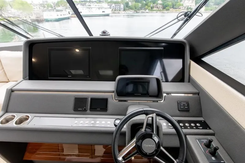 Slide: The Image of 2024 Maritimo M55 yacht helm with modern navigation screens and controls. - 67