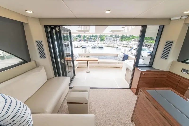 Slide: The Image of Luxurious interior of 2024 Maritimo M55 yacht with marina view through glass doors. - 69