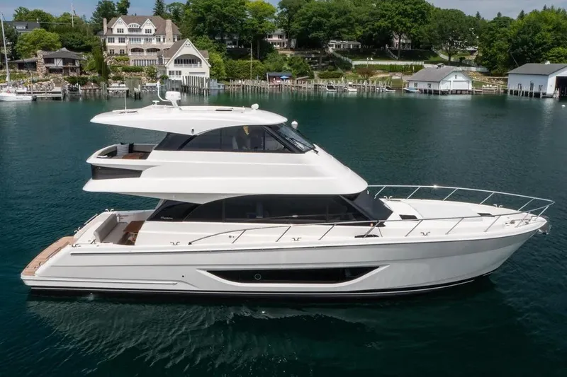 Slide: The Image of 2024 Maritimo M55 yacht on serene water with scenic background. - 7