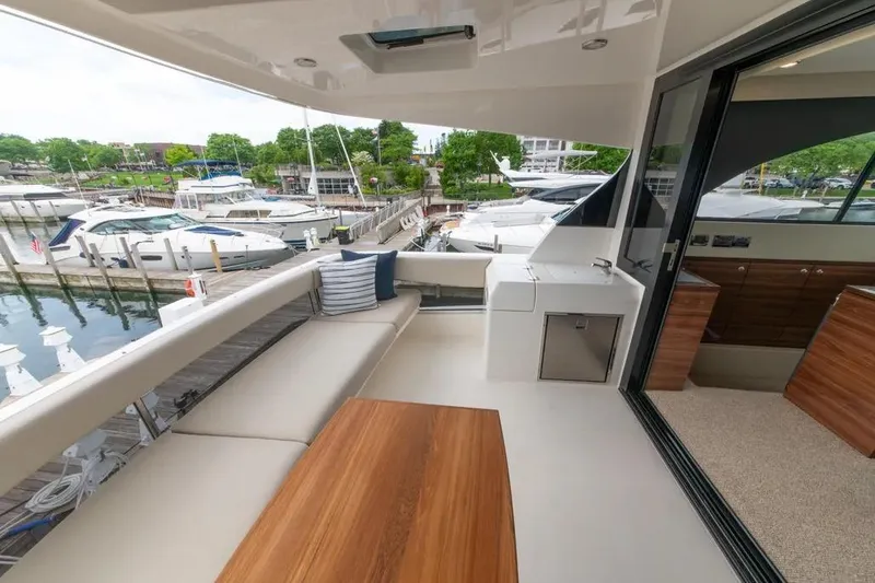 Slide: The Image of Luxurious 2024 Maritimo M55 yacht deck with seating, table, and marina view. - 72