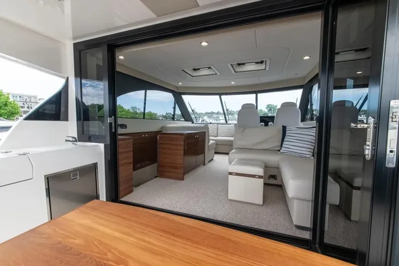 Slide: The Image of 2024 Maritimo M55 yacht interior with modern seating and panoramic windows. - 74