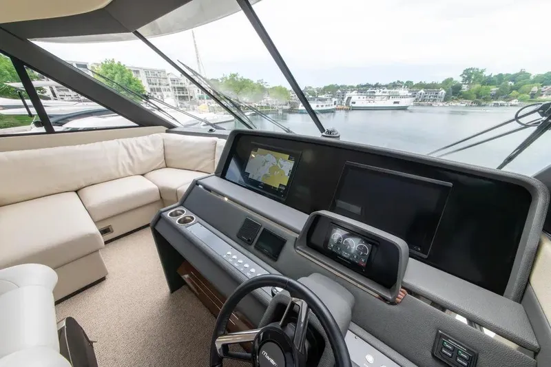 Slide: The Image of 2024 Maritimo M55 yacht helm with modern navigation displays and luxurious seating. - 77