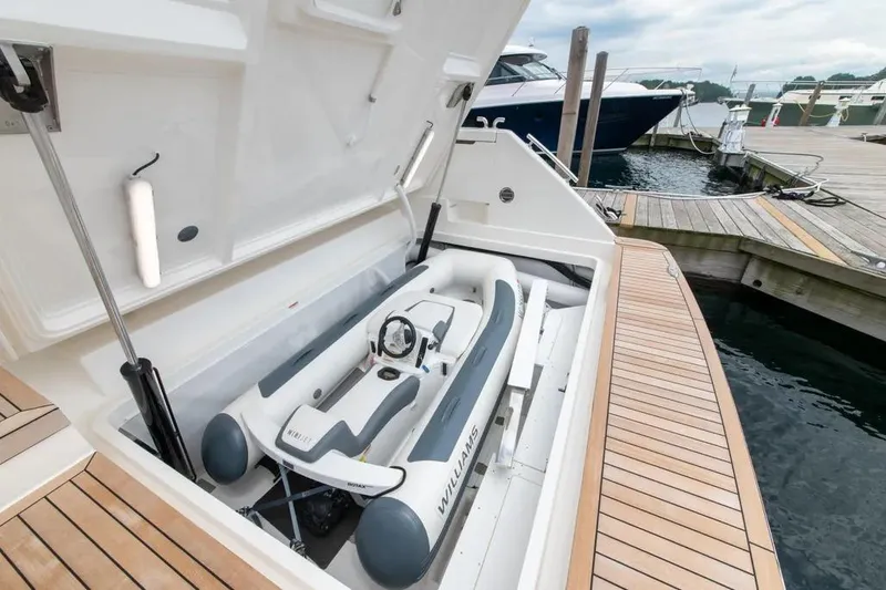 Slide: The Image of 2024 Maritimo M55 yacht with tender storage at marina dock. - 83