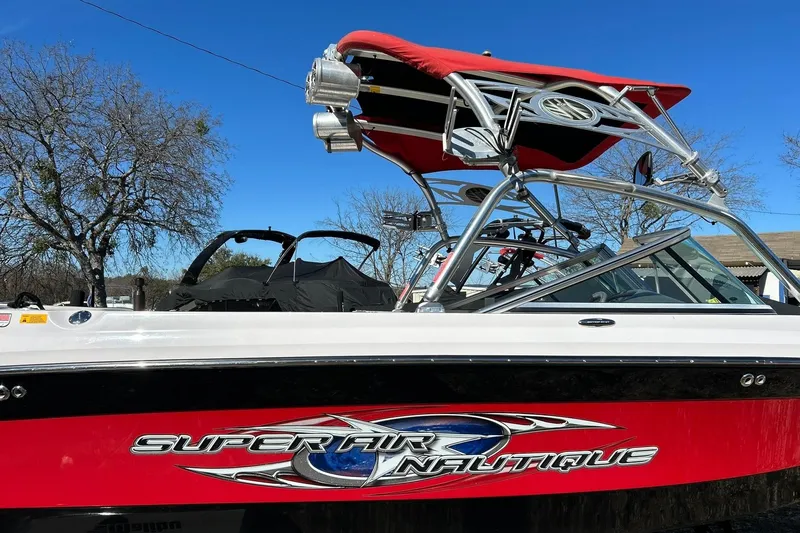 Slide: The Image of 2007 Nautique Super Air Nautique 220 boat with red accents and wakeboard tower. - 13