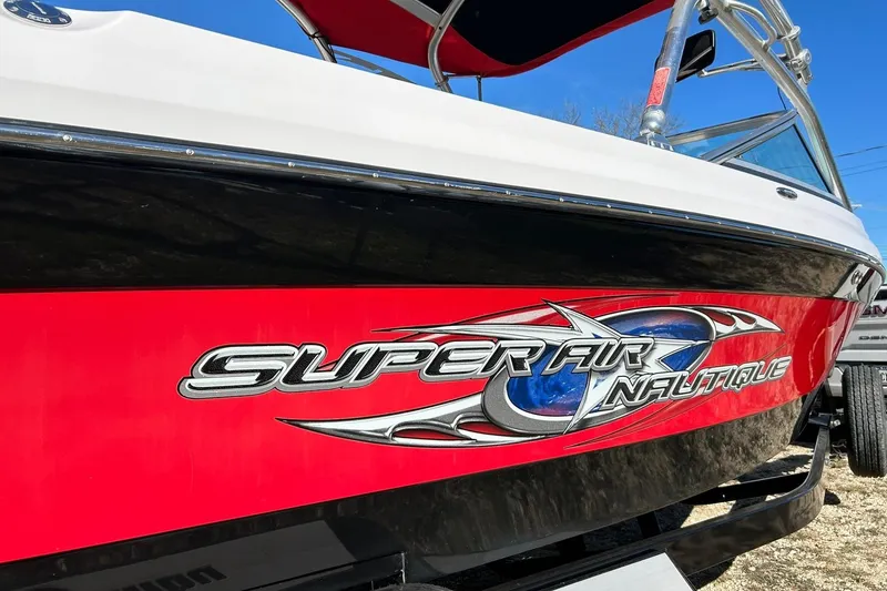 Slide: The Image of 2007 Nautique Super Air Nautique 220 boat with red and black design. - 15