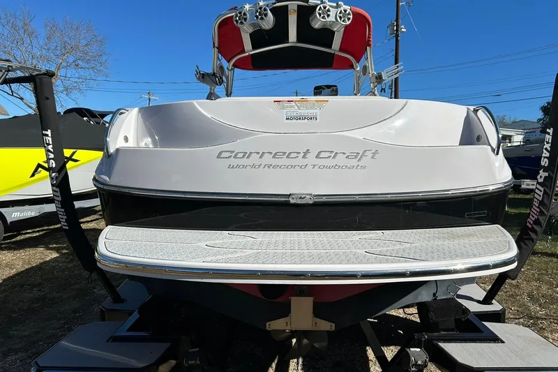 Slide: The Image of 2007 Nautique Super Air Nautique 220 boat rear view, showcasing Correct Craft branding. - 21