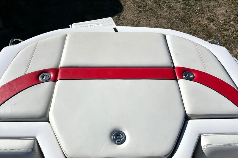 Slide: The Image of 2007 Nautique Super Air Nautique 220 boat seat with red accents and white upholstery. - 24