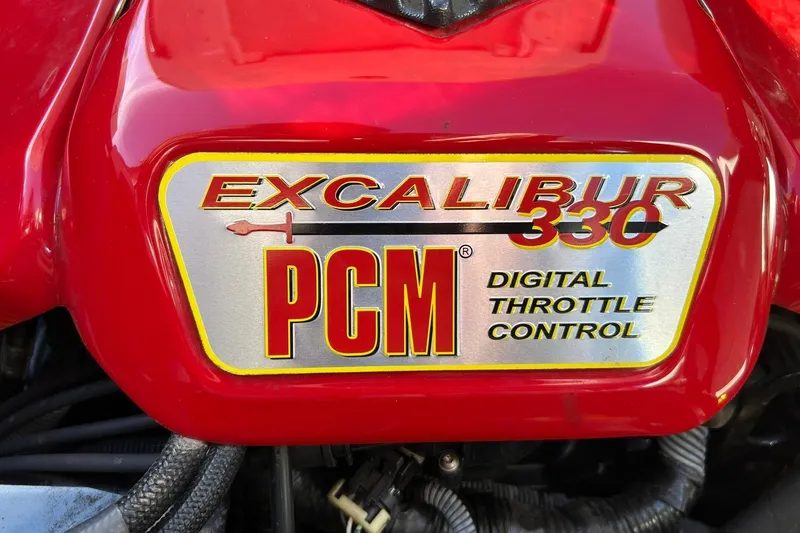 Slide: The Image of Red PCM Excalibur 330 engine cover with digital throttle control label. - 26