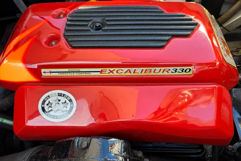 Slide: The Image of Red Excalibur 330 engine cover with digital throttle control, ultra-low emissions badge. - 27