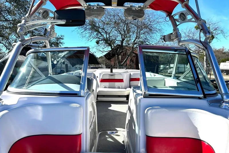 Slide: The Image of 2007 Nautique Super Air Nautique 220 boat interior with red and white seating, open windshield. - 29
