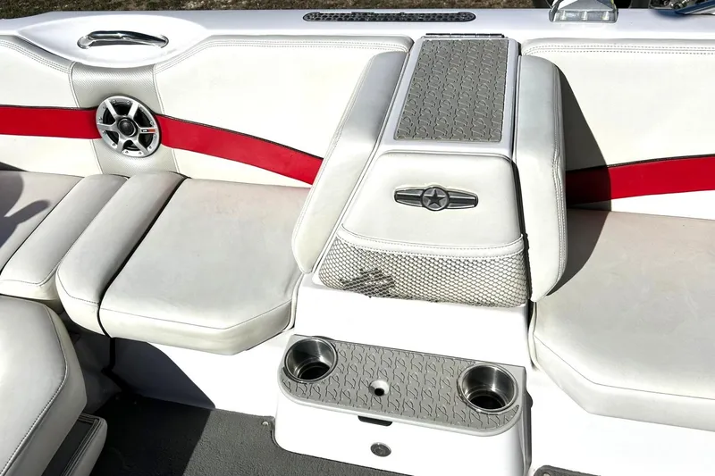 Slide: The Image of 2007 Nautique Super Air Nautique 220 interior with white and red seating, cup holders, and speaker. - 35