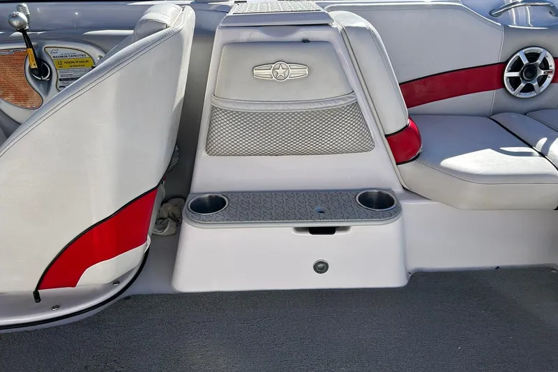 Slide: The Image of 2007 Nautique Super Air Nautique 220 interior with red accents and cup holders. - 36