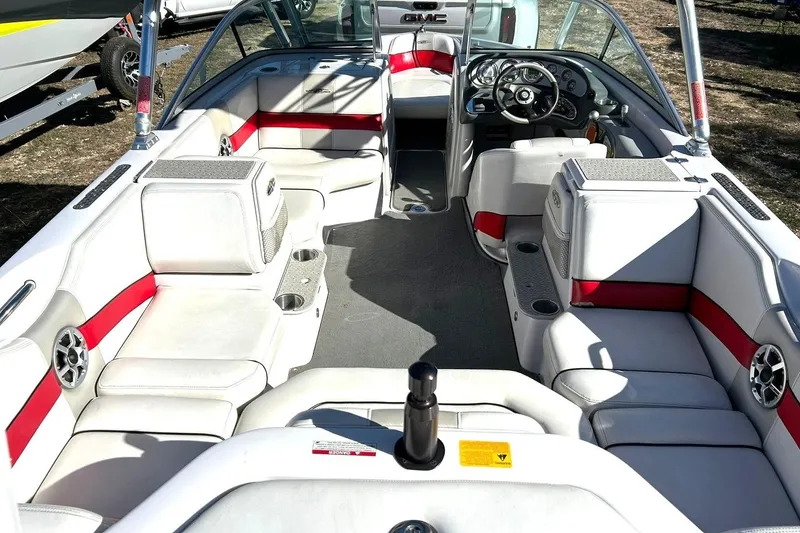Slide: The Image of 2007 Nautique Super Air Nautique 220 boat interior with red and white seating and steering wheel. - 4