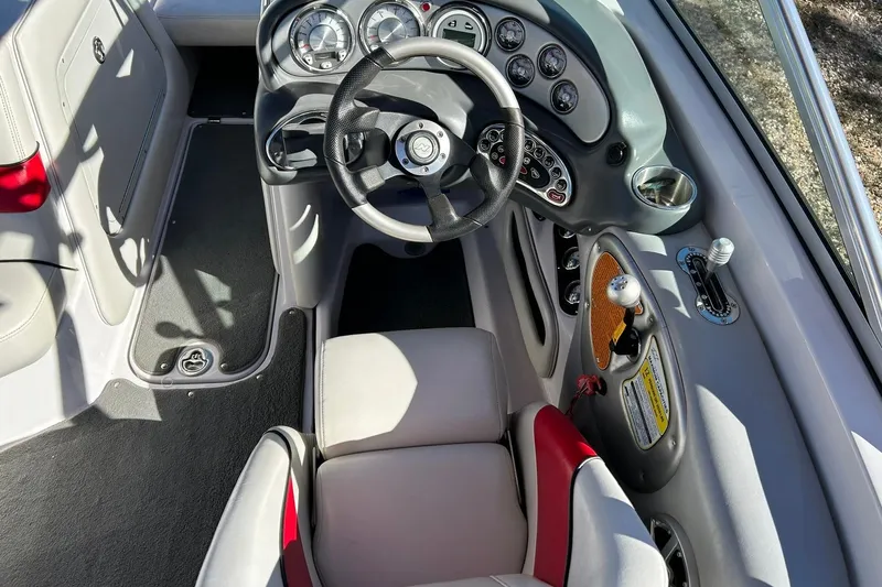 Slide: The Image of 2007 Nautique Super Air Nautique 220 boat cockpit with steering wheel and control panel. - 41