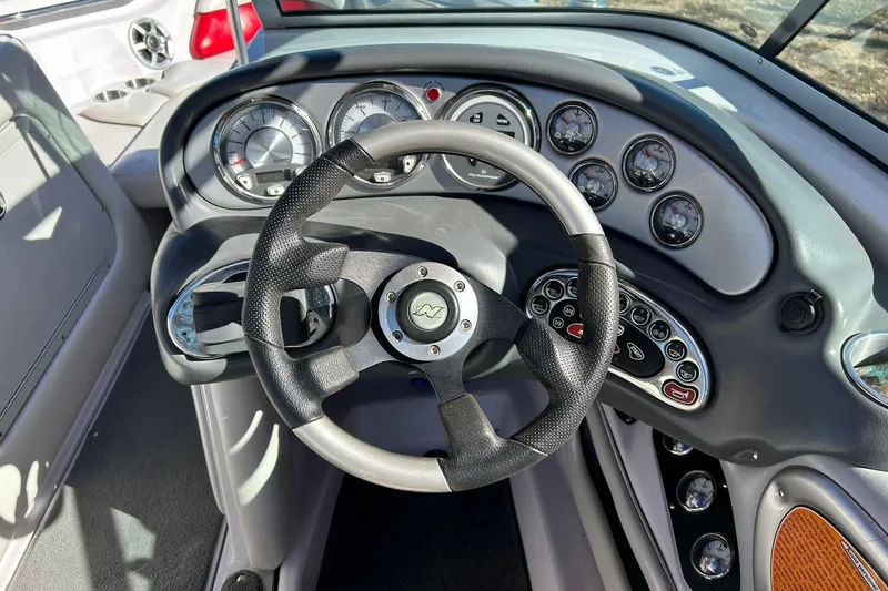 Slide: The Image of 2007 Nautique Super Air Nautique 220 dashboard with steering wheel and gauges. - 42