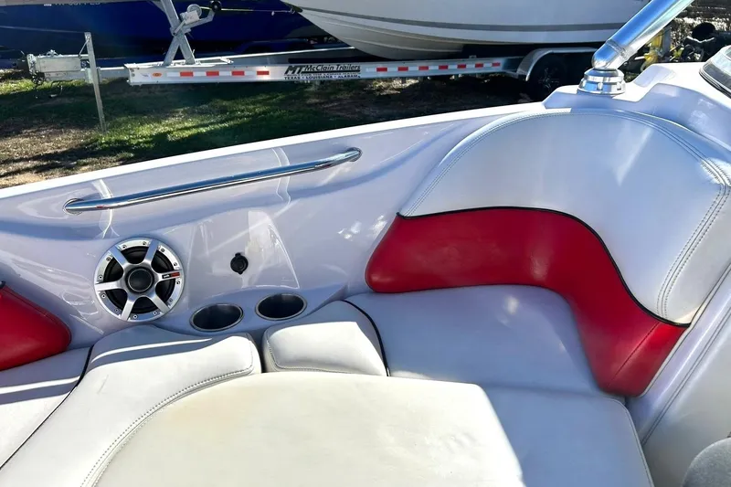 Slide: The Image of 2007 Nautique Super Air Nautique 220 interior with red and white seating, speaker, and cup holders. - 44