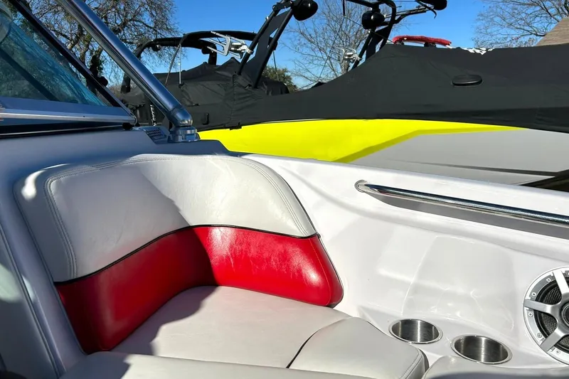 Slide: The Image of 2007 Nautique Super Air Nautique 220 interior with red and white seating, cup holders, and speaker. - 45