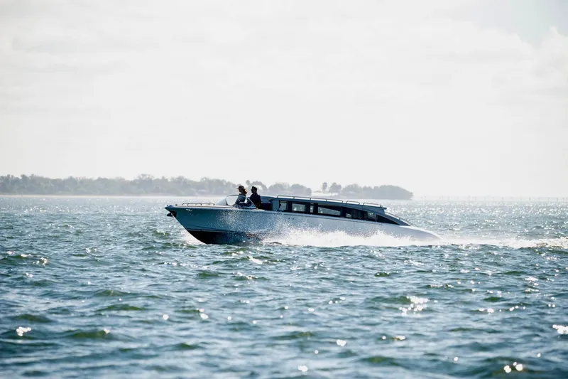 Slide: The Image of 2016 Hodgdon Venetian boat cruising on open water under a bright sky. - 12