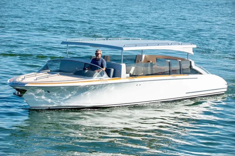 Slide: The Image of 2016 Hodgdon Venetian boat cruising on calm blue water. - 4