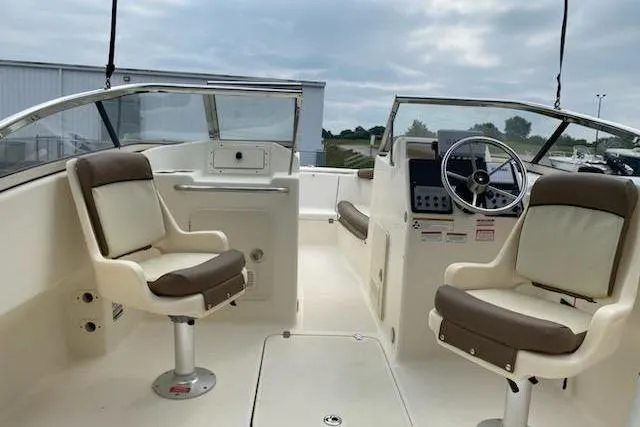Slide: The Image of 2018 Scout Dorado 210 boat interior with dual seats and steering wheel. - 7