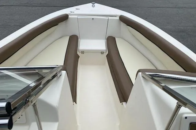 Slide: The Image of 2018 Scout Dorado 210 boat interior with cushioned seating and open deck. - 8