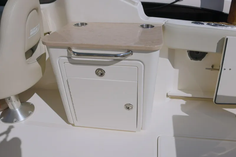 Slide: The Image of 2022 Boston Whaler 240 Vantage boat interior with storage compartment and seating. - 11