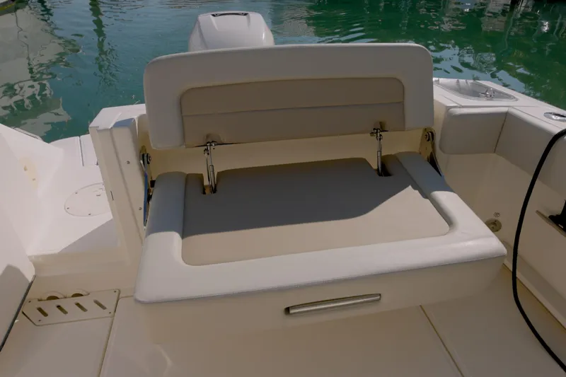 Slide: The Image of 2022 Boston Whaler 240 Vantage boat seat with water in background. - 13