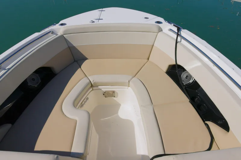 Slide: The Image of 2022 Boston Whaler 240 Vantage boat interior with beige seating and speakers. - 5