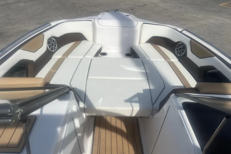 Slide: The Image of 2022 Yamaha Boats 212SE interior with cushioned seating and built-in speakers. - 4