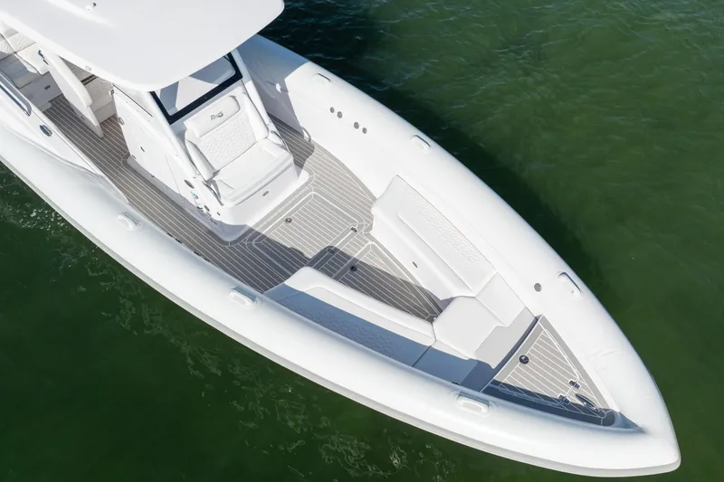 Slide: The Image of Aerial view of 2025 Airship 340 boat with sleek white design on green water. - 14