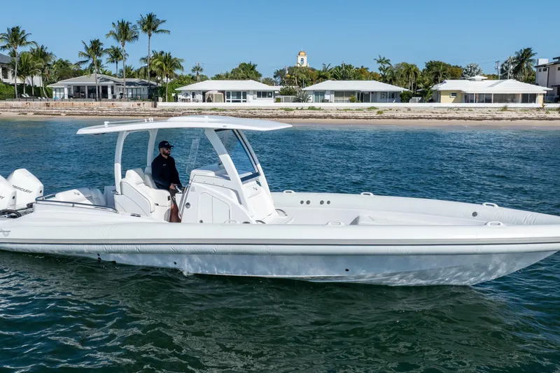Slide: The Image of 2025 Airship 340 boat cruising near a tropical shoreline with palm trees. - 17